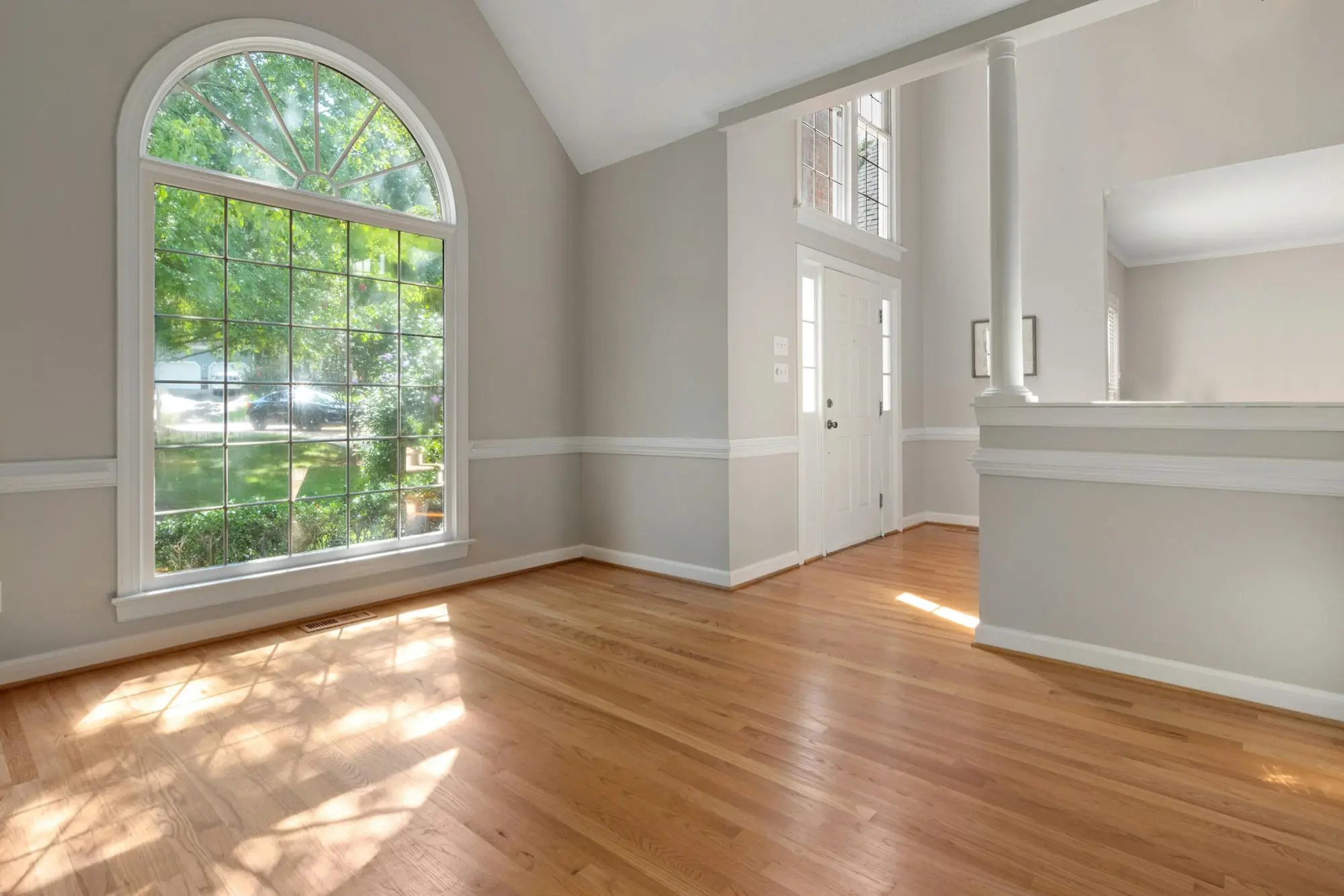 House for sale with hardwood floors and light gray walls with white wainscoting