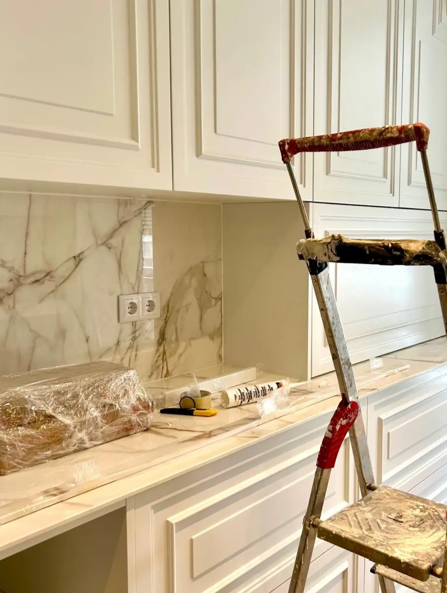Classic white kitchen with decorative mouldings, custom-designed for a renovation project by Margarida Bugarim.