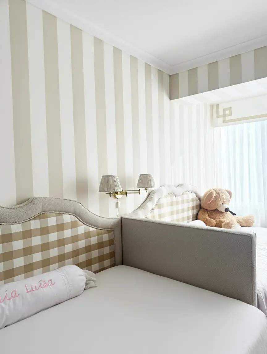 Children's bedroom with two beds and headboards in beige and white checked fabric