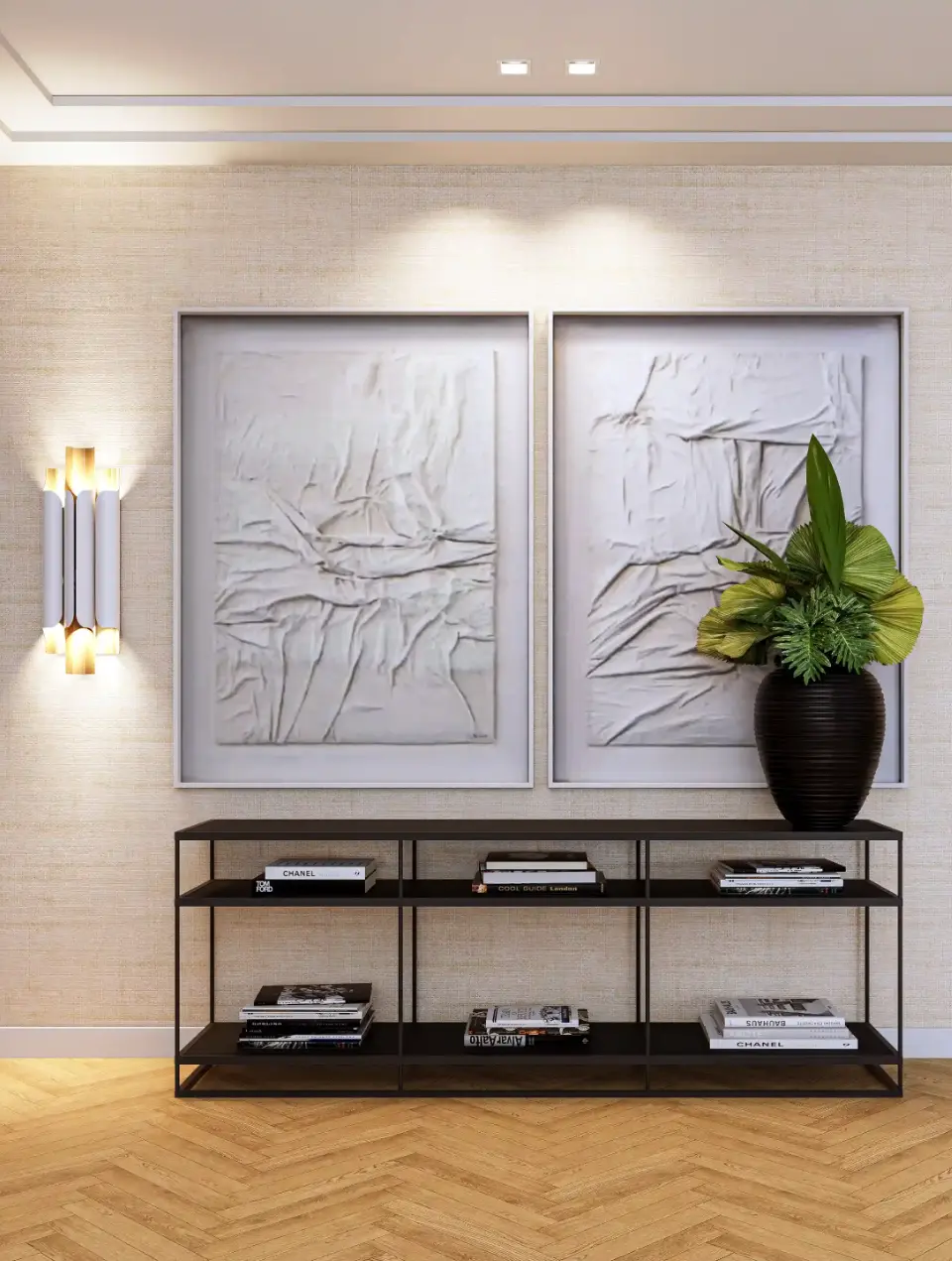 Detalhe de decoração de sala com consola em metal preto, quadros contemporâneos brancos e papel de parede texturado beige