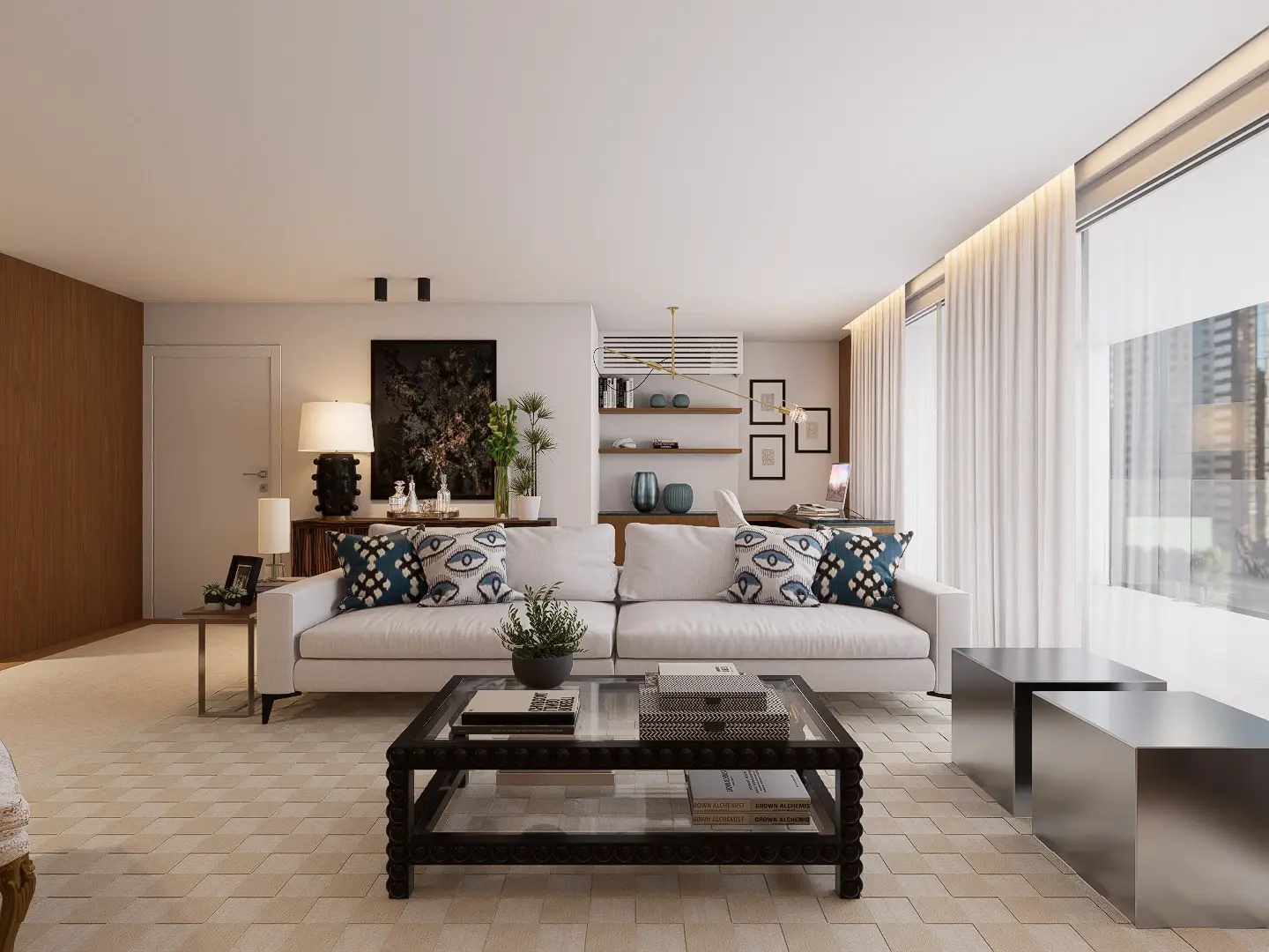 Living room with a contemporary white sofa, a black wooden and glass coffee table and stainless steel pouffes; an office area can be seen in the back