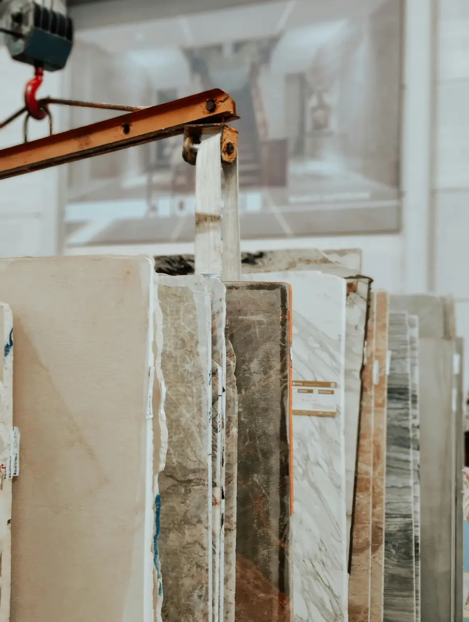 Pieces of natural marble in various shades of beige, white, and gray, to be selected at a quarry