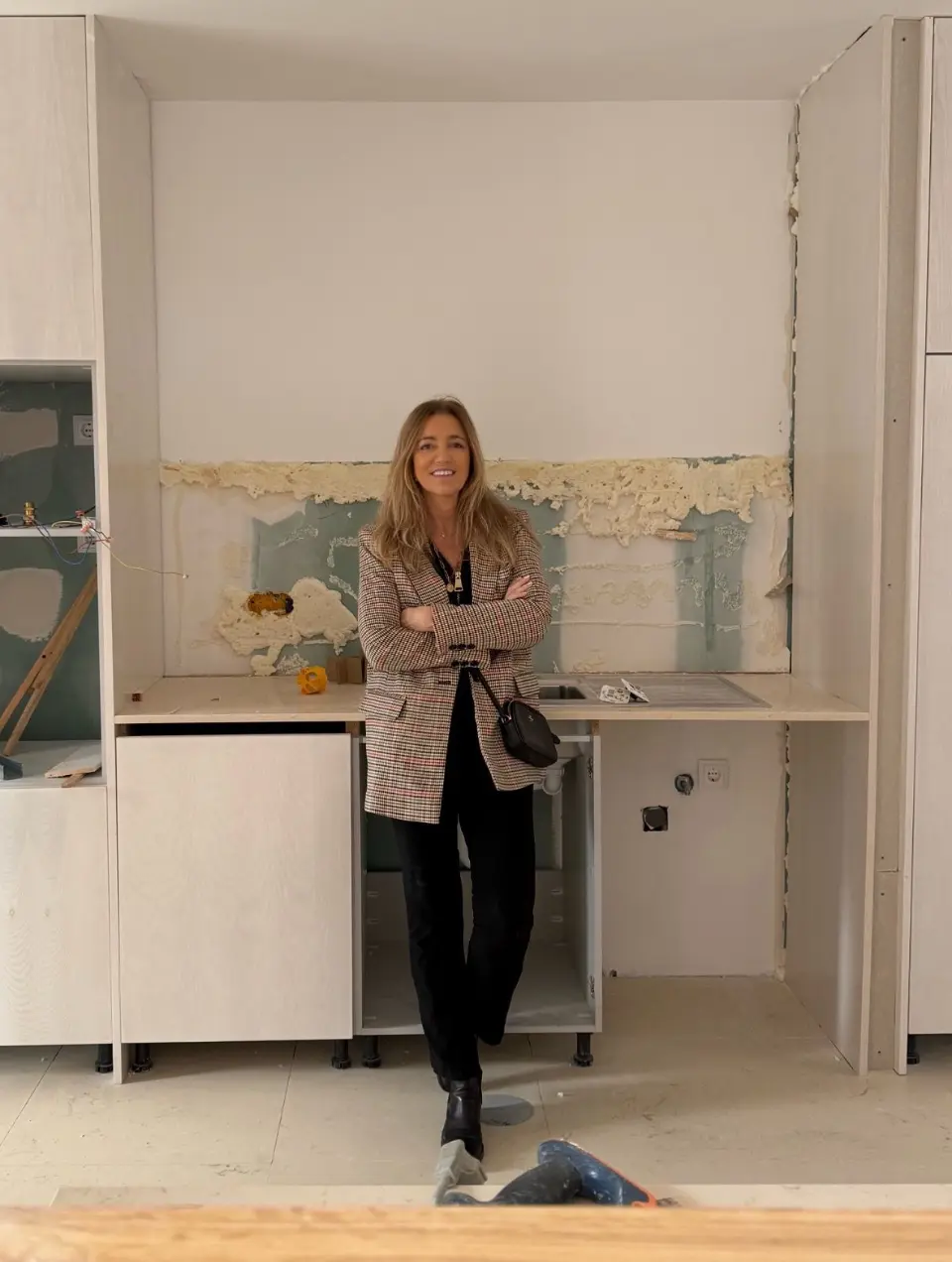 Portrait of Interior Designer Margarida Bugarim in a kitchen being renovated by the studio