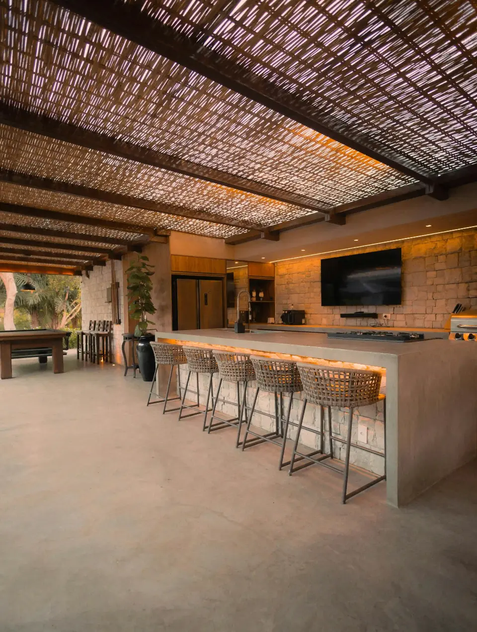 Outdoor barbecue area with gray microcement flooring