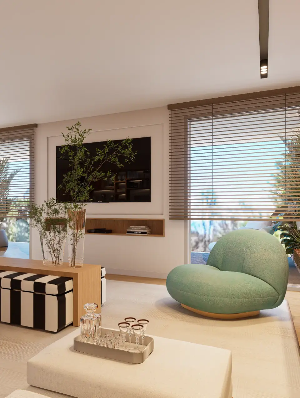 The TV area in the living room, decorated in a contemporary style, features armchairs with curved lines, an oak coffee table and a striped pouffe