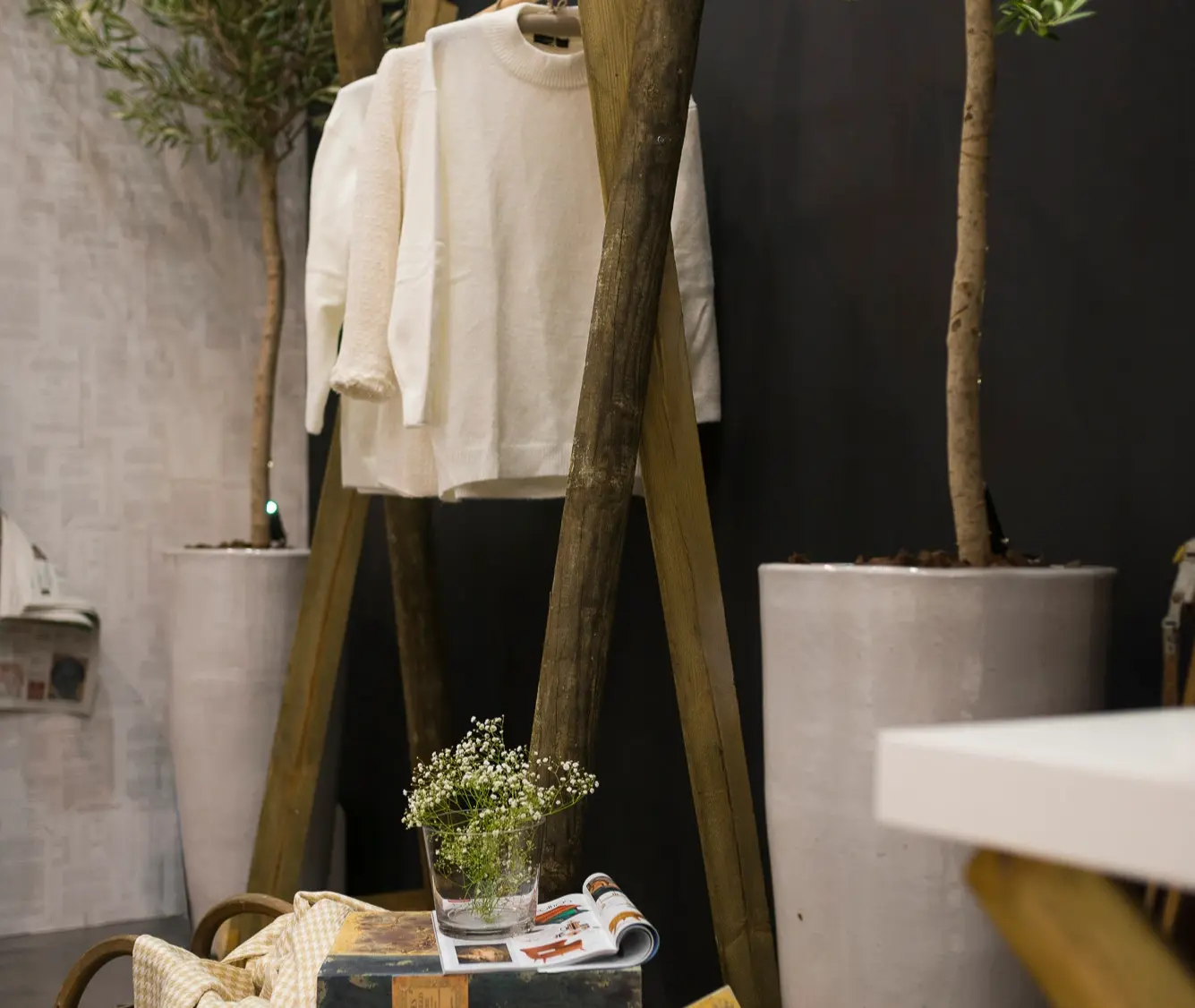 Interior design details: Custom-designed charriot made from rustic logs, antique sleigh, and books against a black backdrop