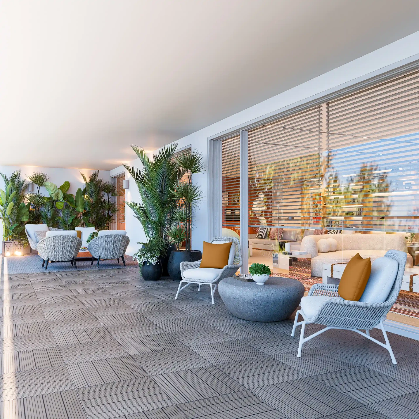 Spacious terrace with sea views decorated with rope sofas and armchairs, brick-colored cushions, and tropical vegetation